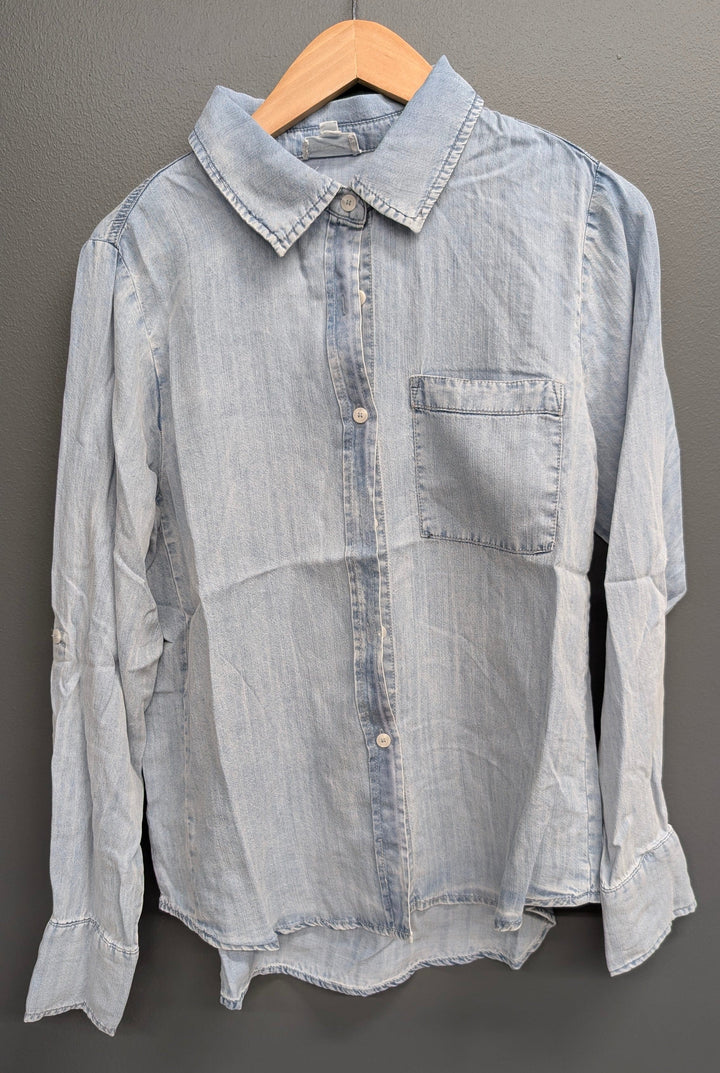 Light blue Avery button-down top by Stitch &amp; Co., featuring a classic collar and button closure, shown on a hanger.