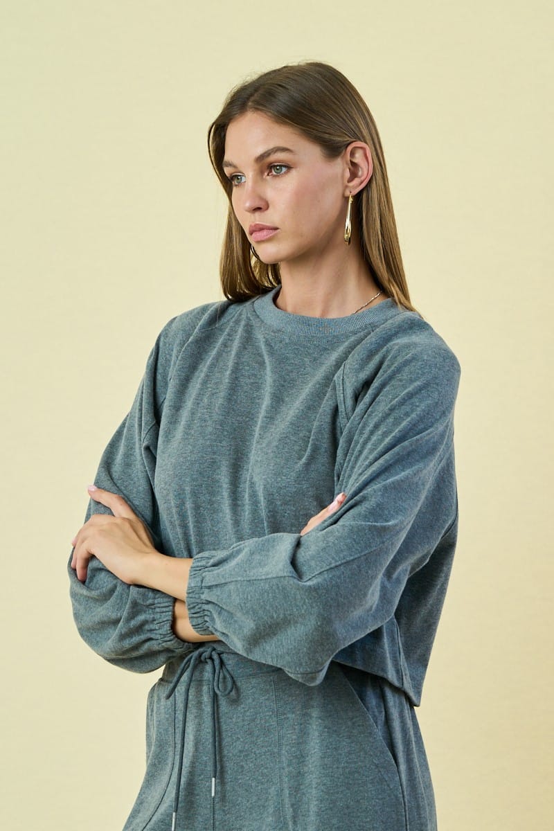 The Greii Malaya Buttoned Sweatshirt featuring a relaxed fit, button details, and soft fabric in a casual style.