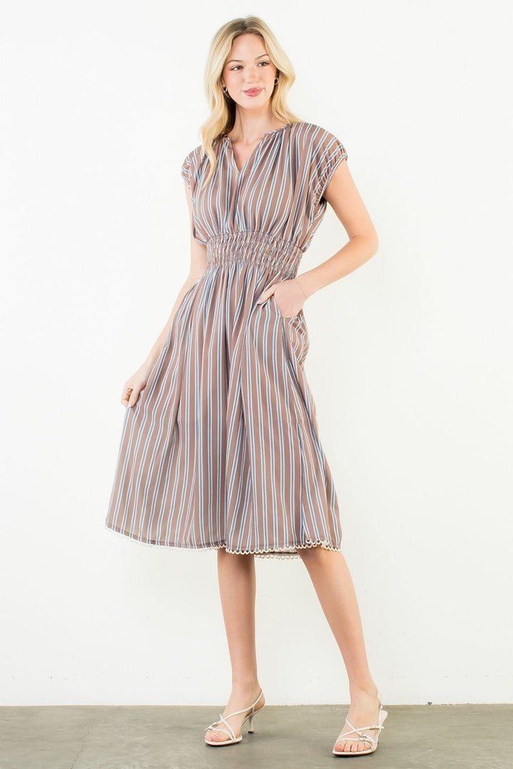 THML Arya striped dress featuring a vibrant pattern and comfortable fit, perfect for casual or semi-formal occasions.