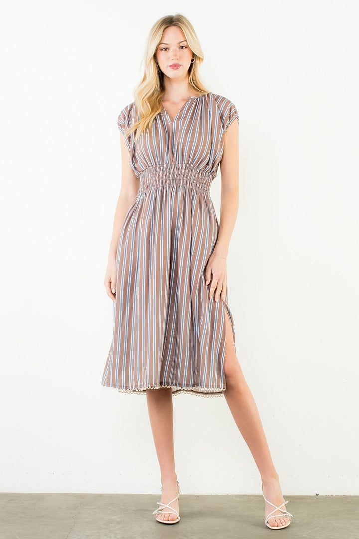Brown Arya striped dress by THML, featuring a casual fit and stylish pattern, displayed on a model.