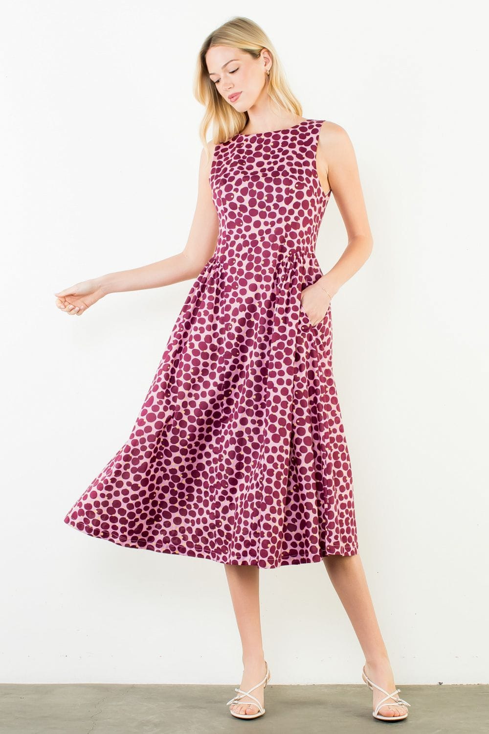 THML Wrenley Dots Midi Dress displayed on a hanger, showcasing its vibrant dot pattern and flowing midi-length design.