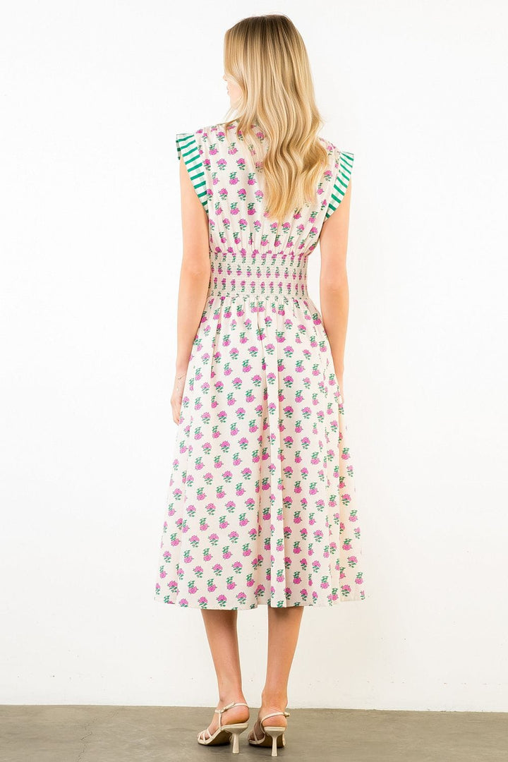 THML Bonnie Smocked Midi Dress featuring a fitted bodice, smocking details, and flowing midi length fabric.