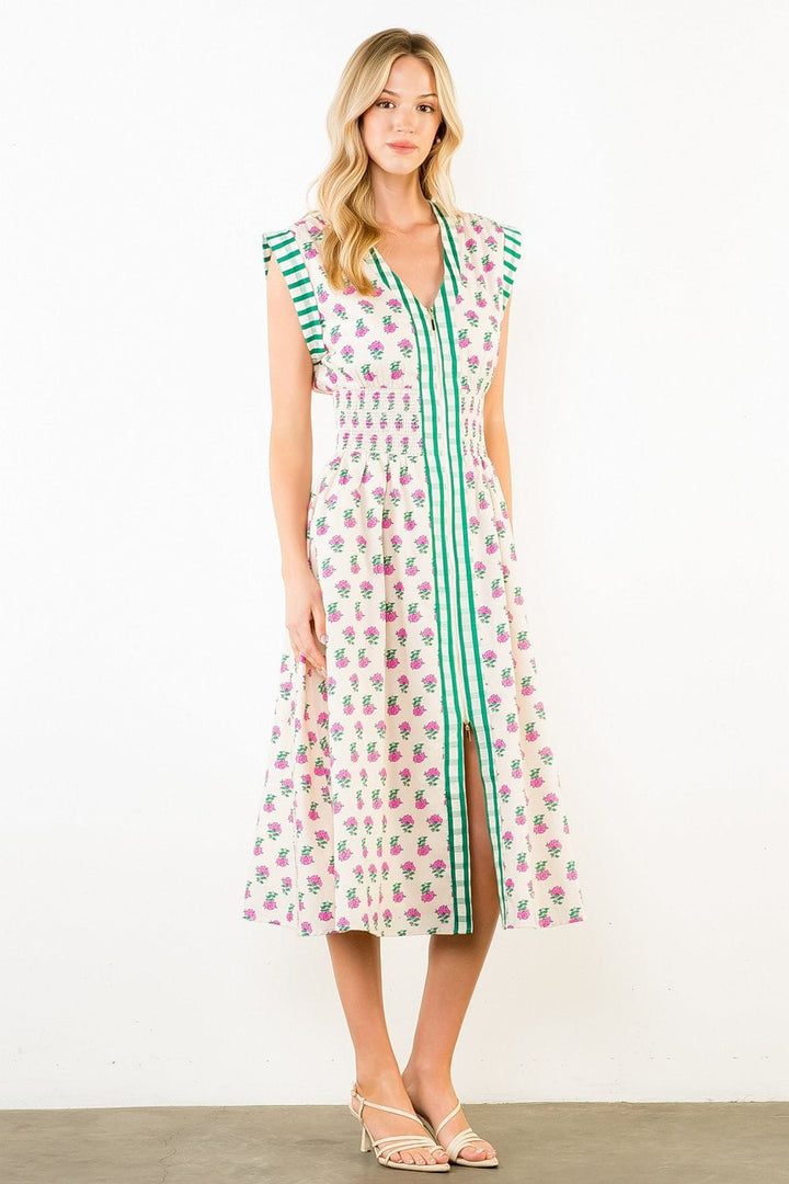 THML Bonnie Smocked Midi Dress featuring a fitted bodice, smocking details, and flowing skirt in soft fabric.