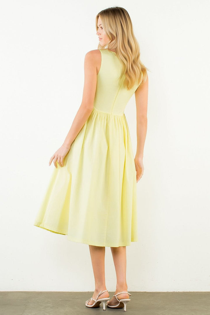 THML Carmen sleeveless midi dress displayed on a hanger, showcasing its elegant design and fabric details.
