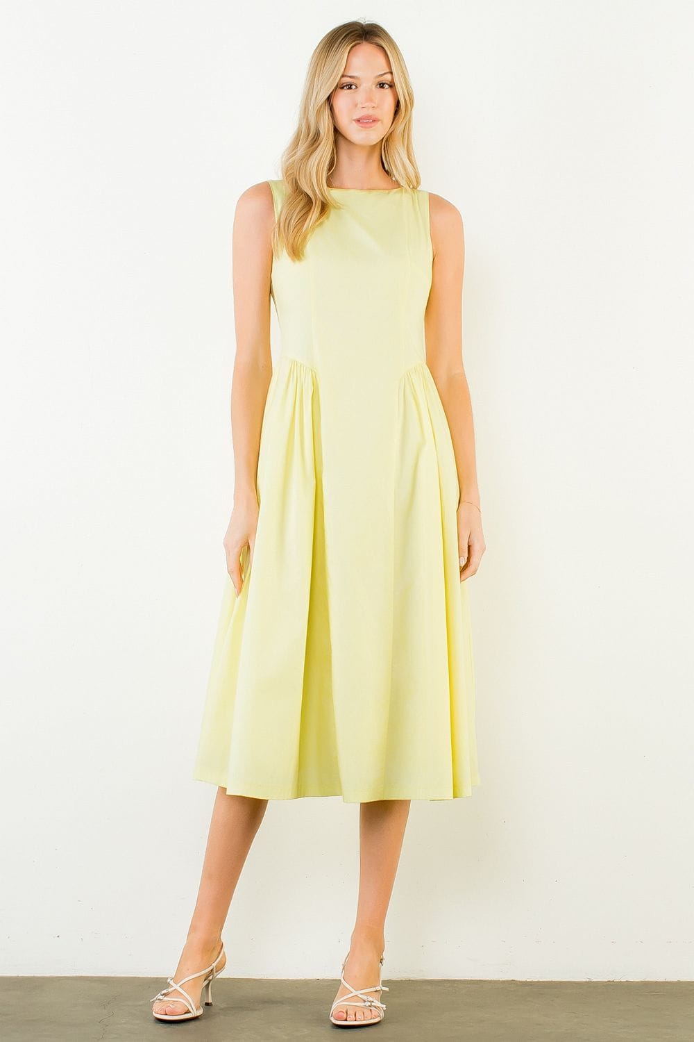 THML Carmen sleeveless midi dress featuring a flowing silhouette and intricate floral pattern, perfect for summer occasions.