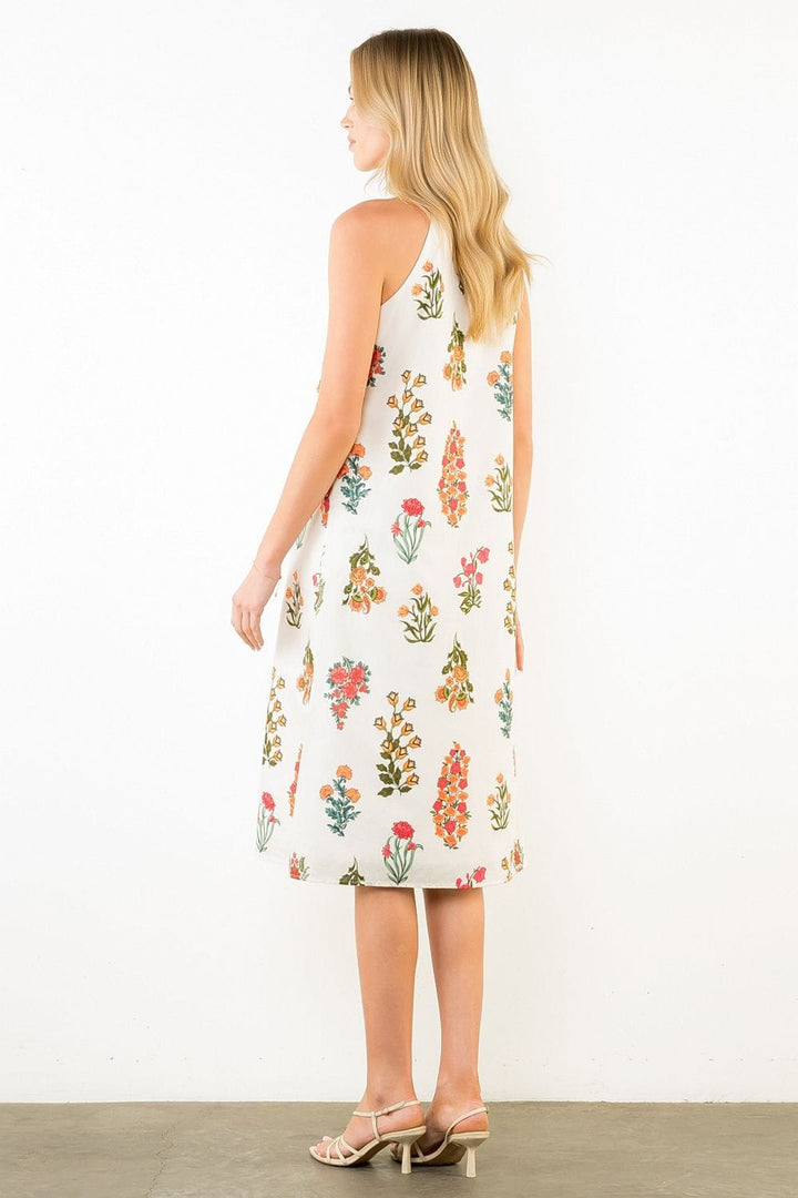 THML Lana Floral Halter Midi Dress displayed on a hanger with a vibrant floral pattern and halter neckline.