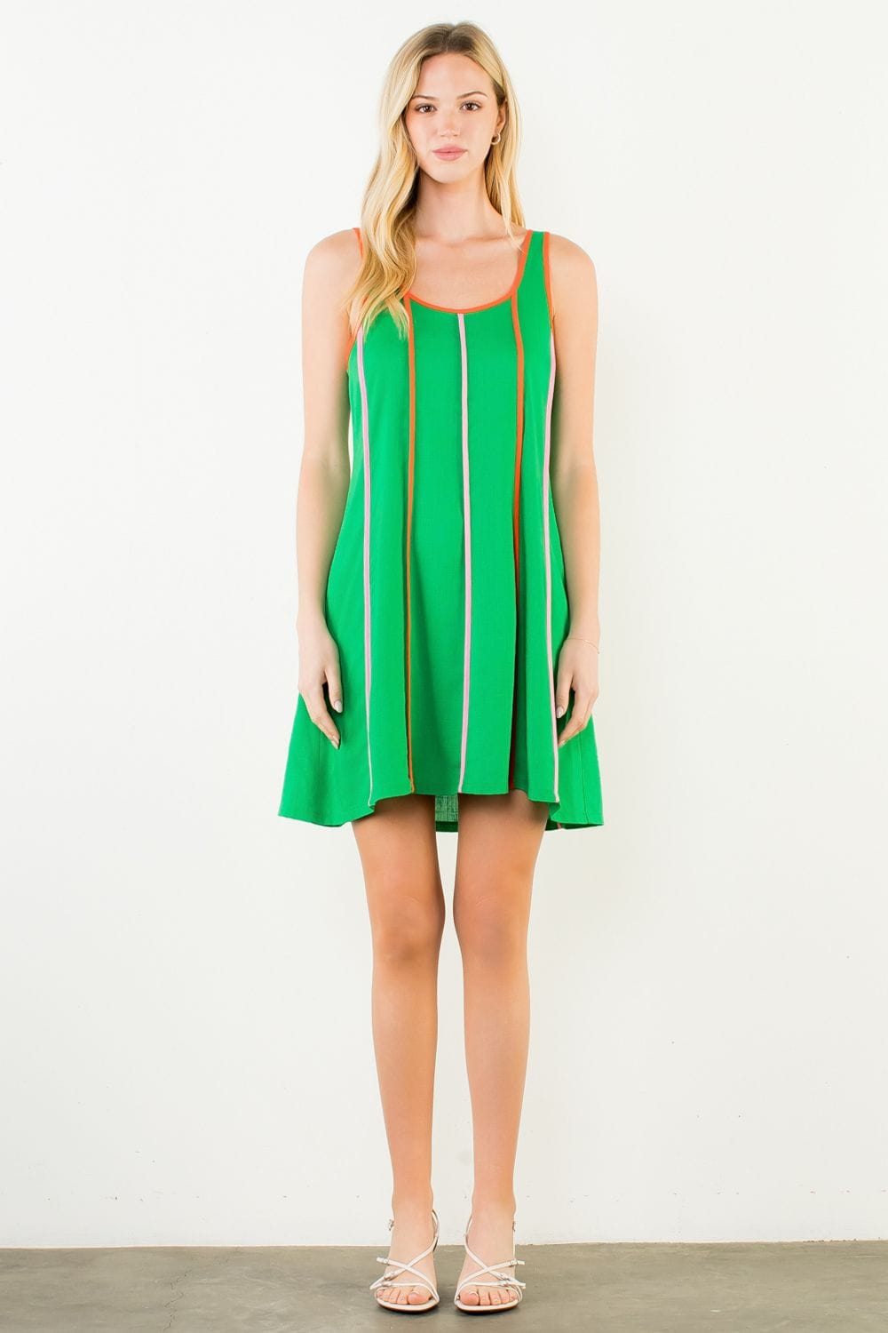 Green THML Milani striped mini dress shown on a model, featuring a fitted silhouette and stylish pattern.