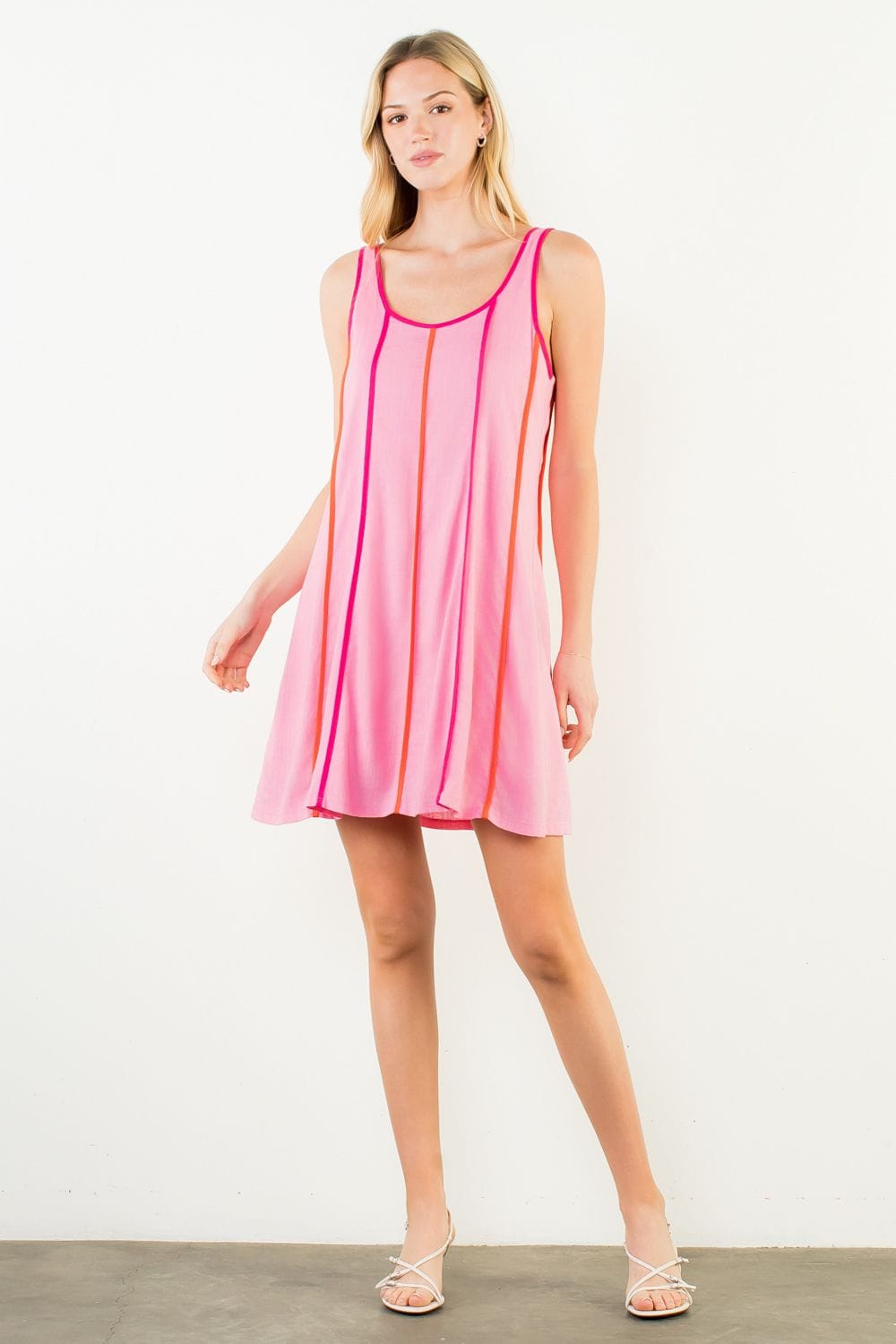 THML Milani striped mini dress with short sleeves and a fitted silhouette, showcasing a vibrant pattern and casual style.