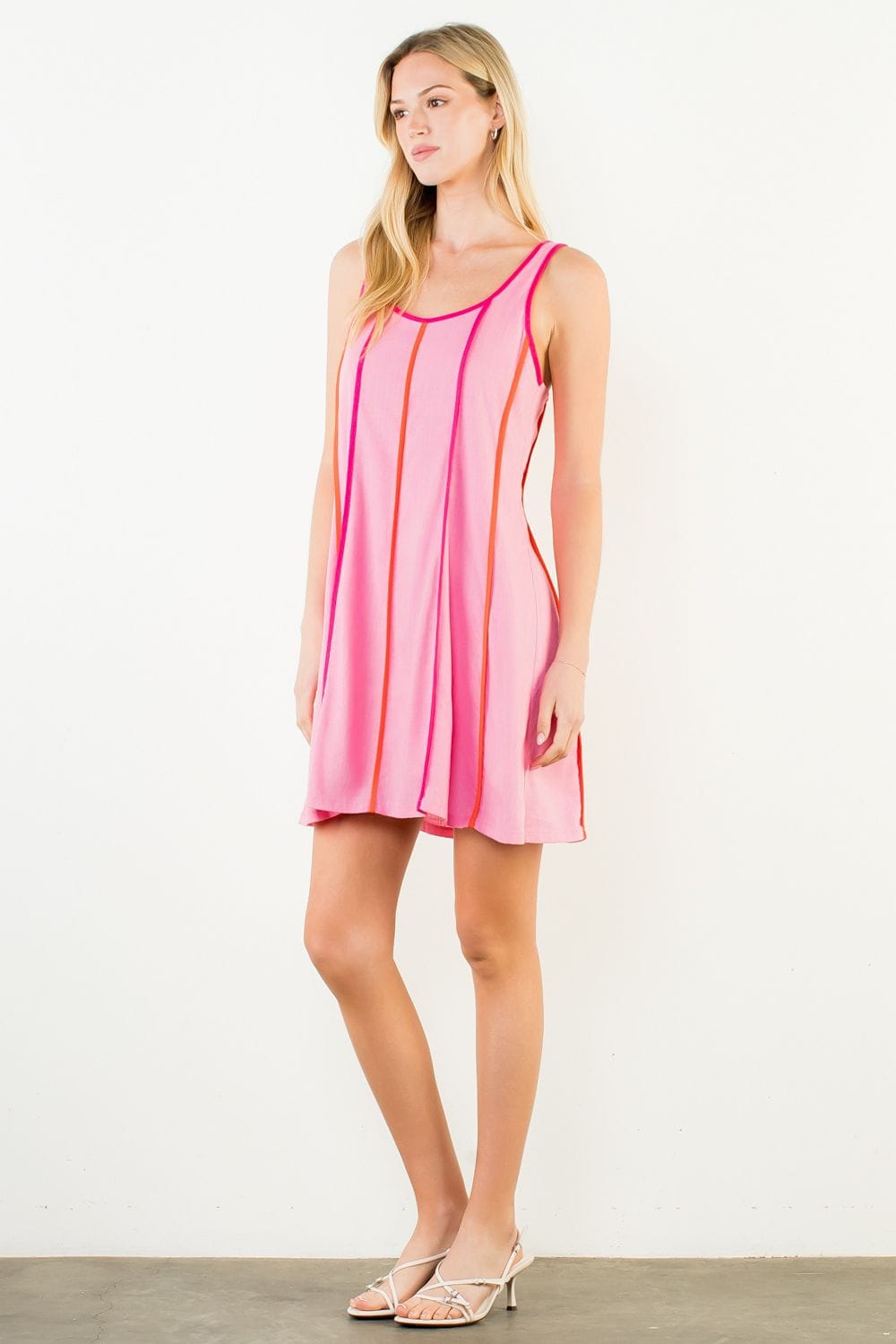 THML Milani striped mini dress featuring a fitted silhouette and vibrant pattern, perfect for casual or summer wear.