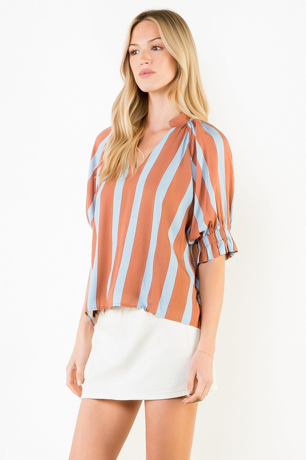 Melany striped V-neck top by THML featuring a stylish pattern and comfortable fit, displayed on a hanger.