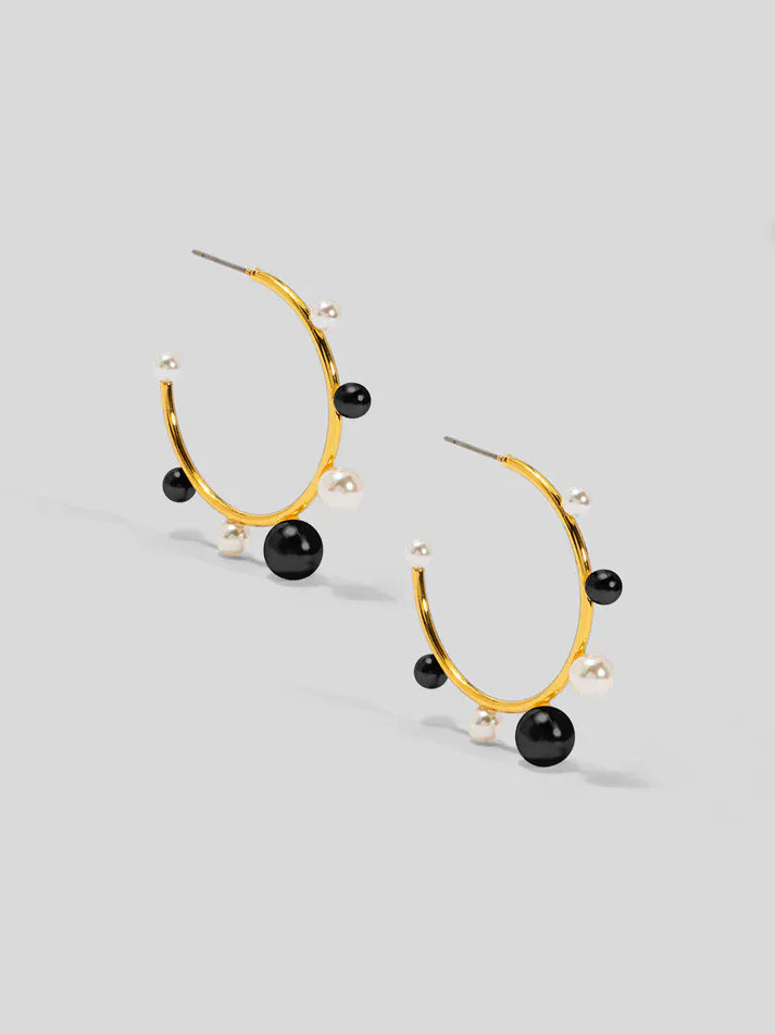 Small decorative black pearl hoop earring by Vioroo, featuring a delicate pearl adornment on a stylish hoop earring.